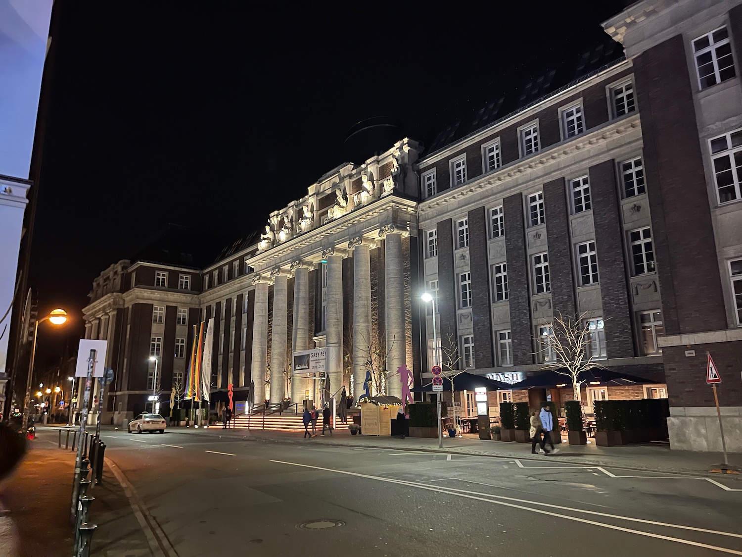 a building with columns and lights at night