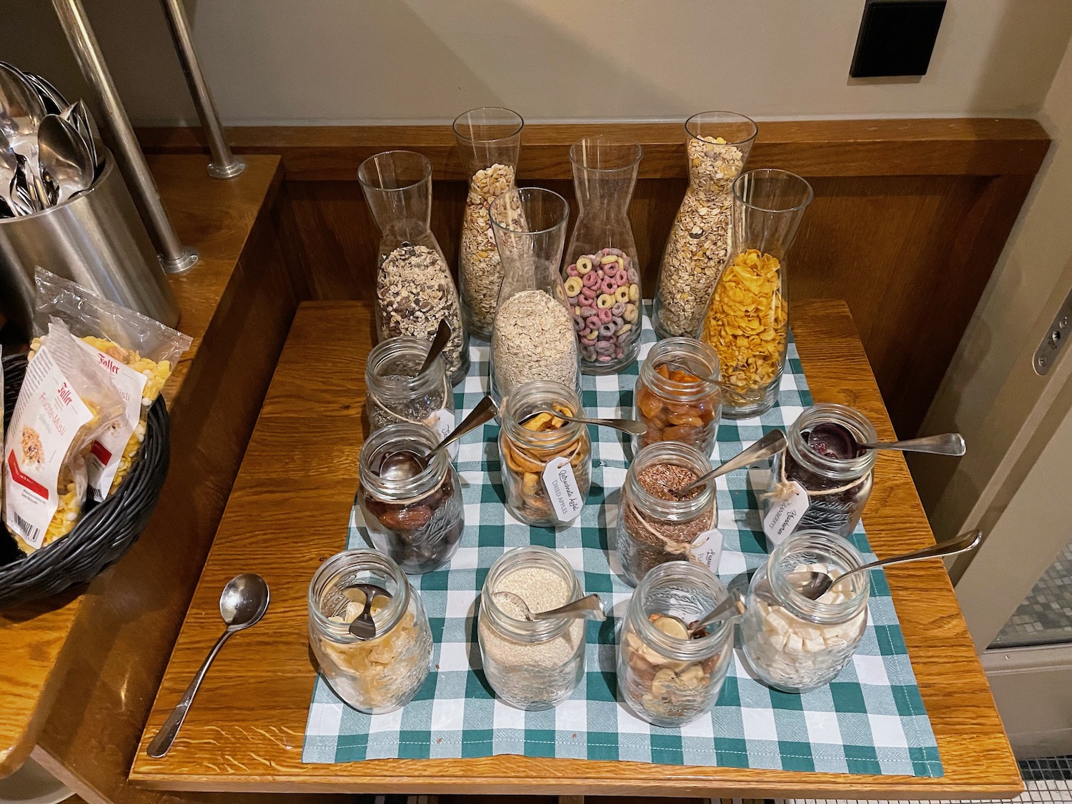 a table with jars of food and spoons