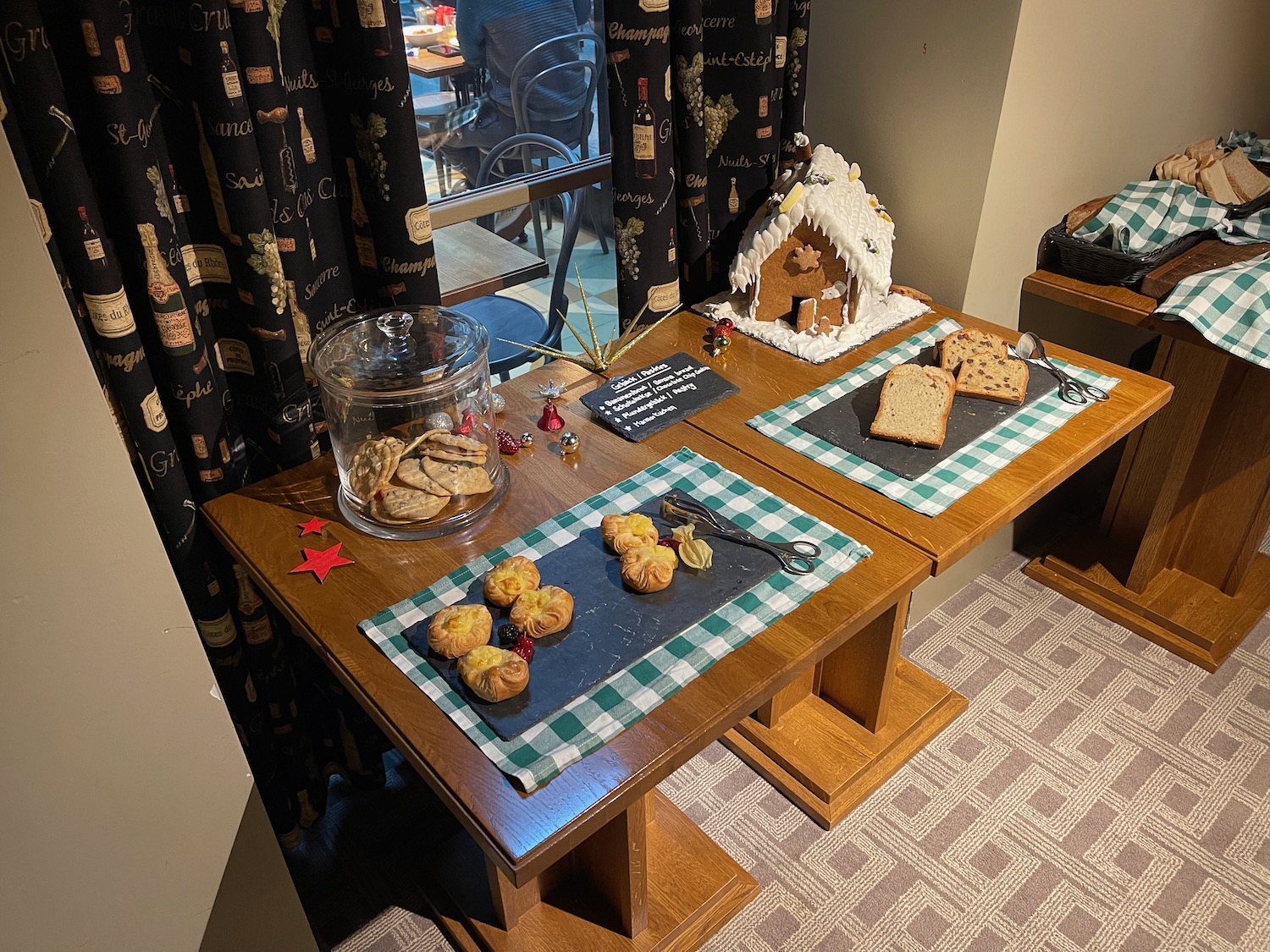 a table with cookies and a gingerbread house