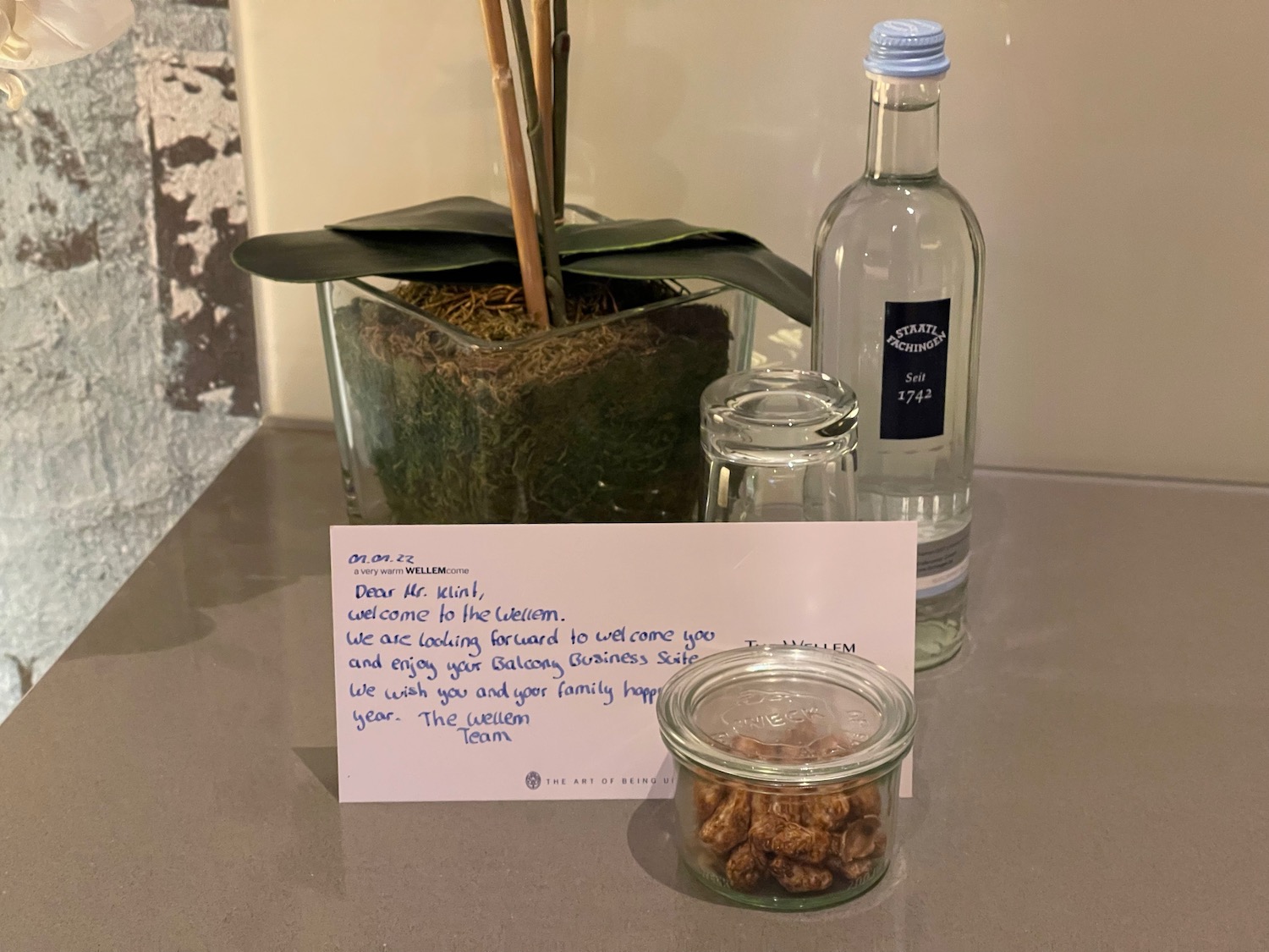 a glass bottle and a glass jar with a note