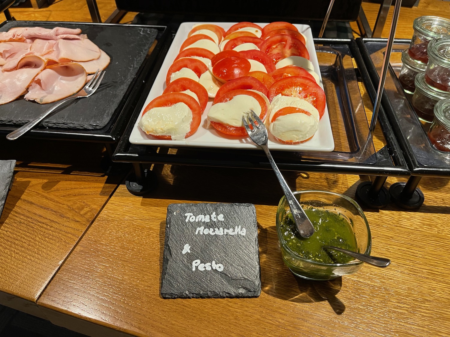 a plate of tomatoes and mozzarella cheese on a table