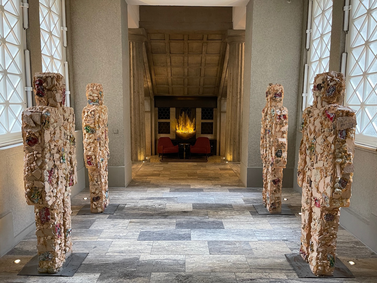 a group of statues in a room with a fireplace