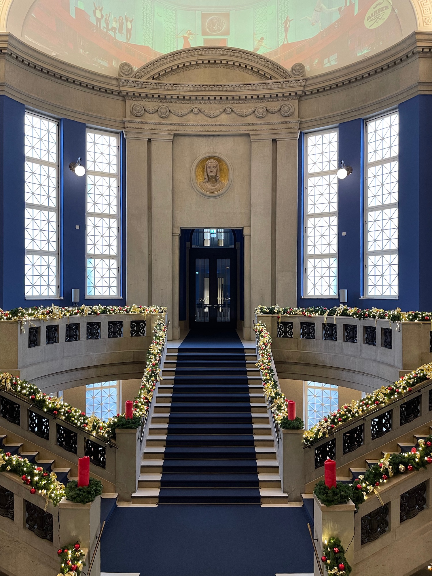 a staircase with lights and a blue carpet