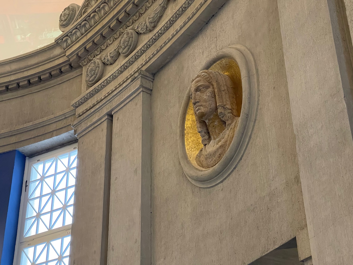 a sculpture of a man's head on a wall