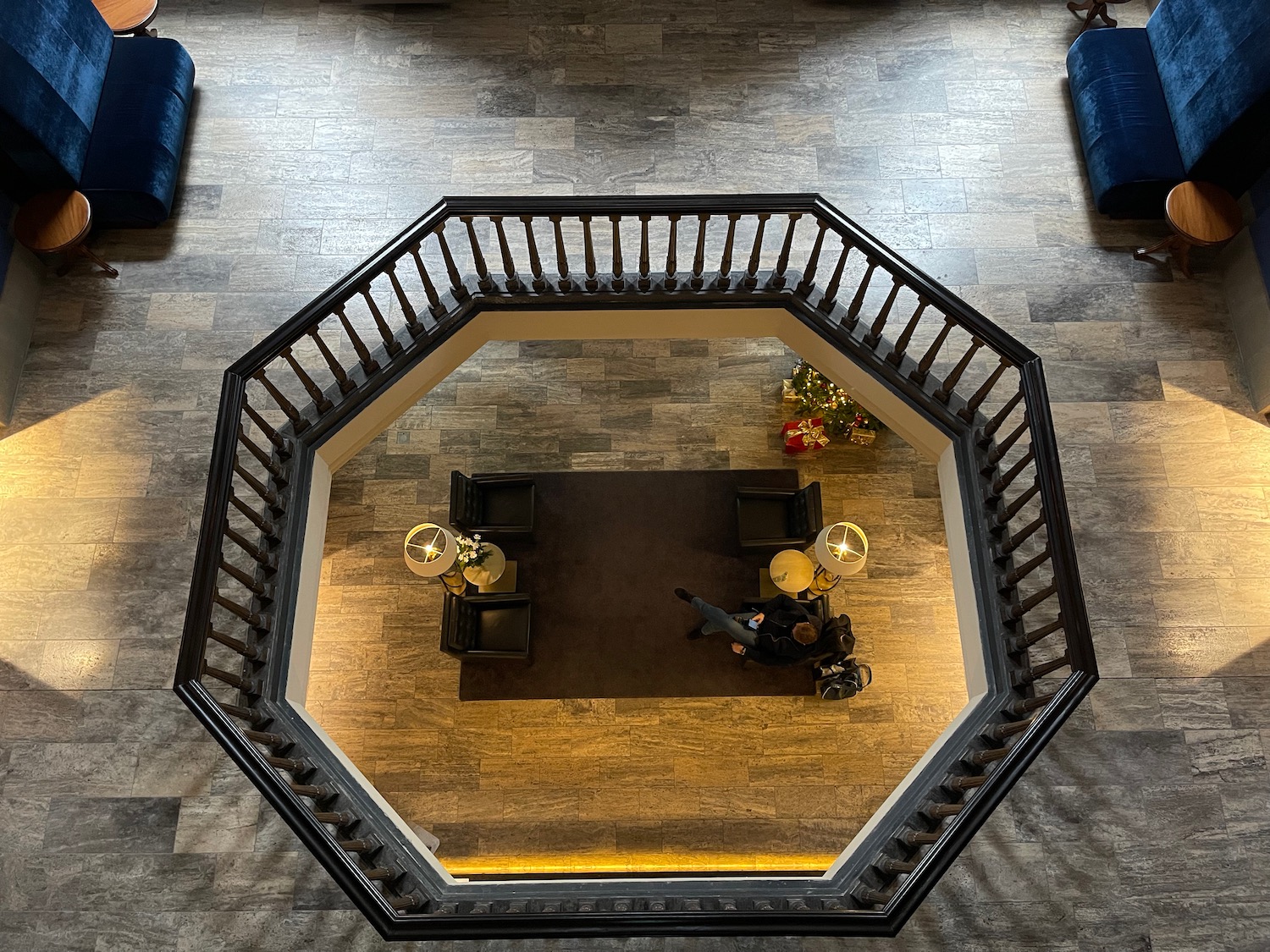 a room with a black railing and a couch