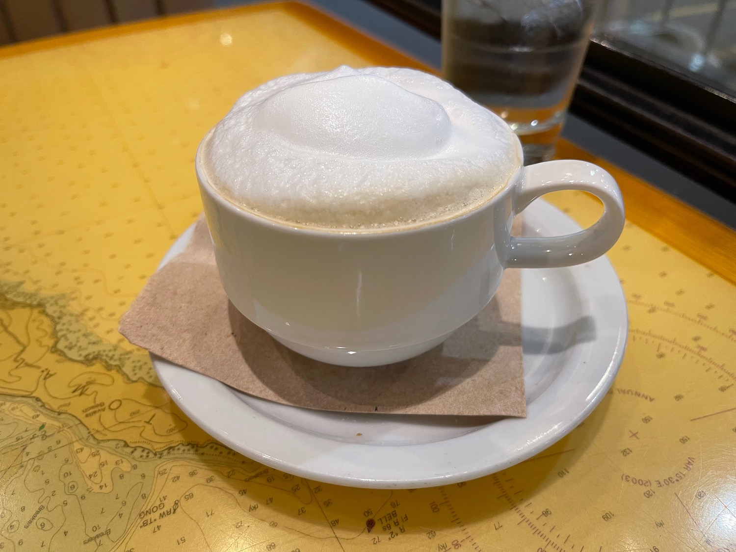 a cup of coffee with foam on top