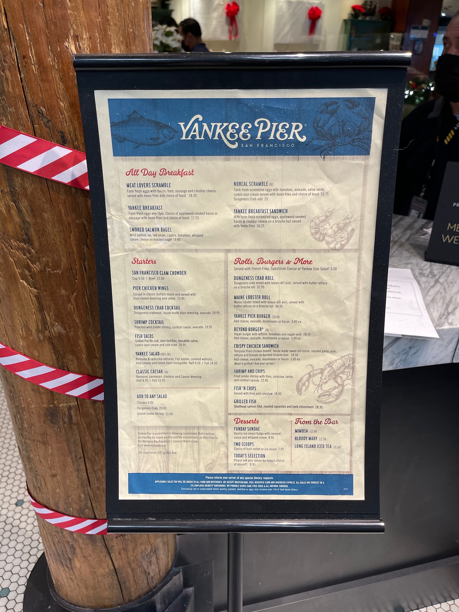 a menu board with a red and white stripe around it