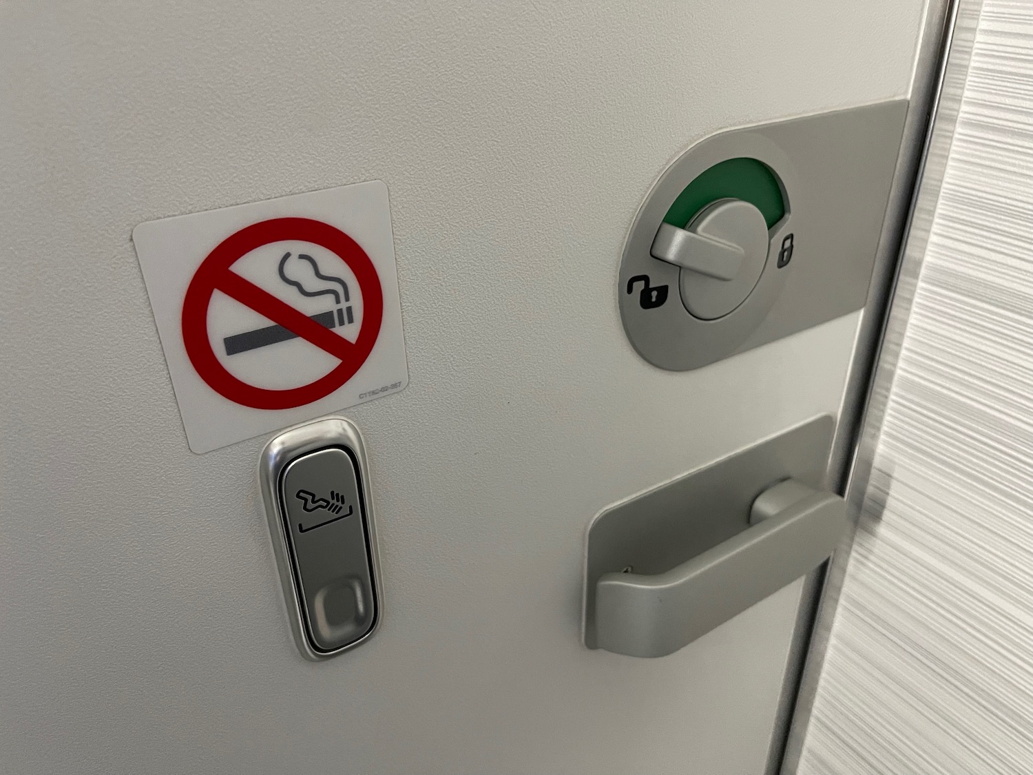 a door with a no smoking sign and a button