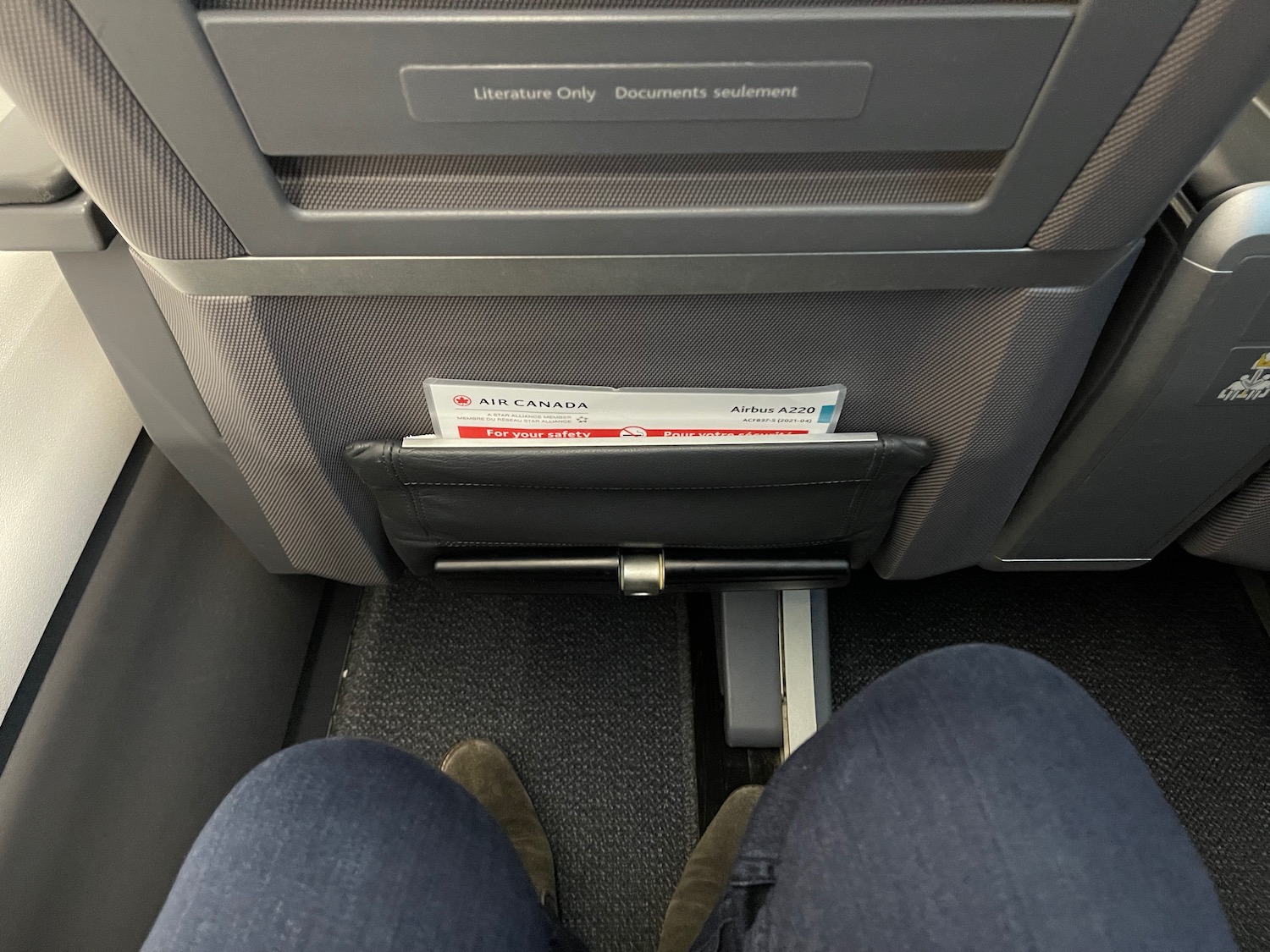 a person's legs in a pocket on an airplane