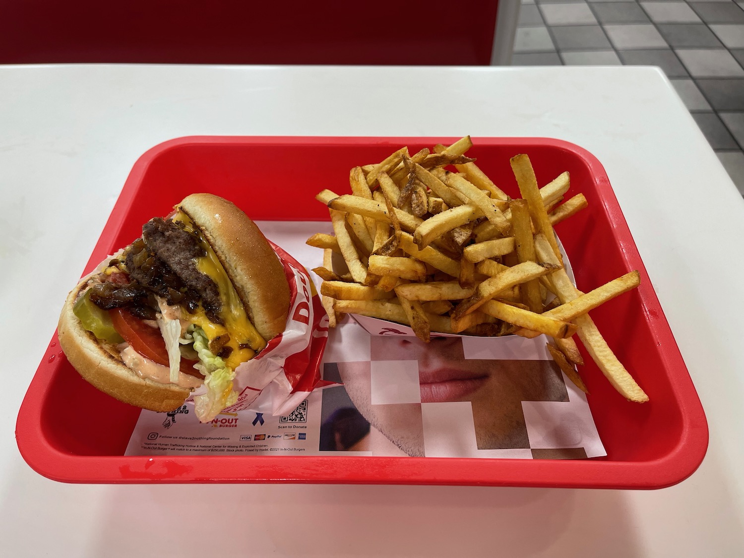 a burger and fries in a red tray