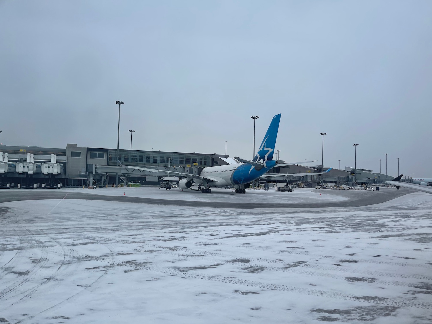 an airplane on a runway in the snow