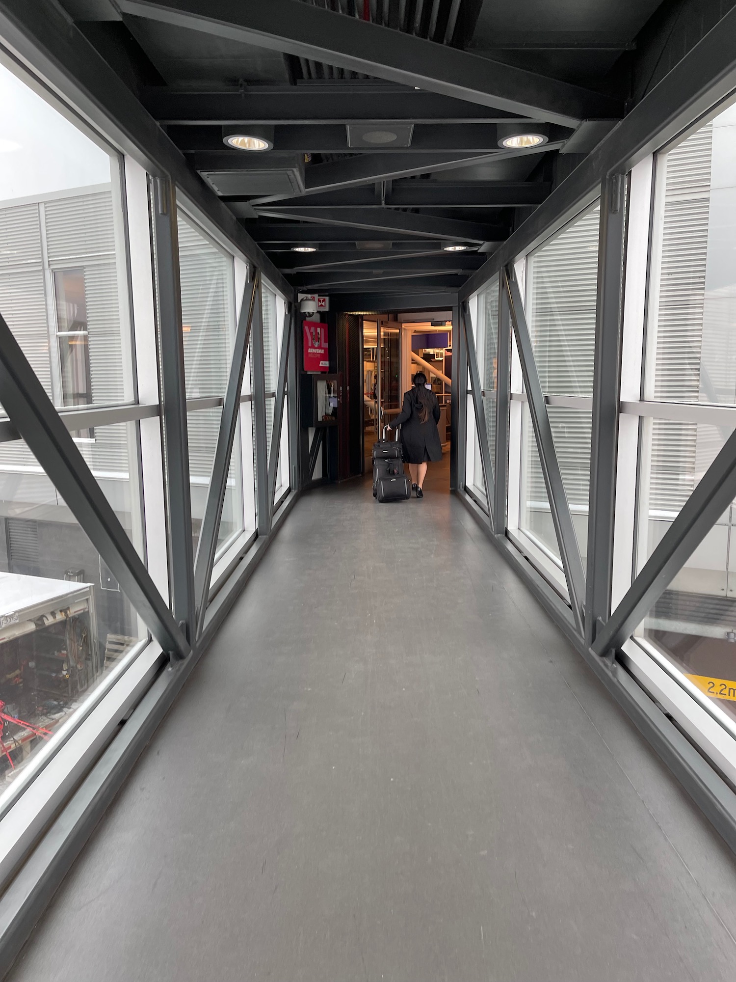 a person walking down a hallway with a luggage