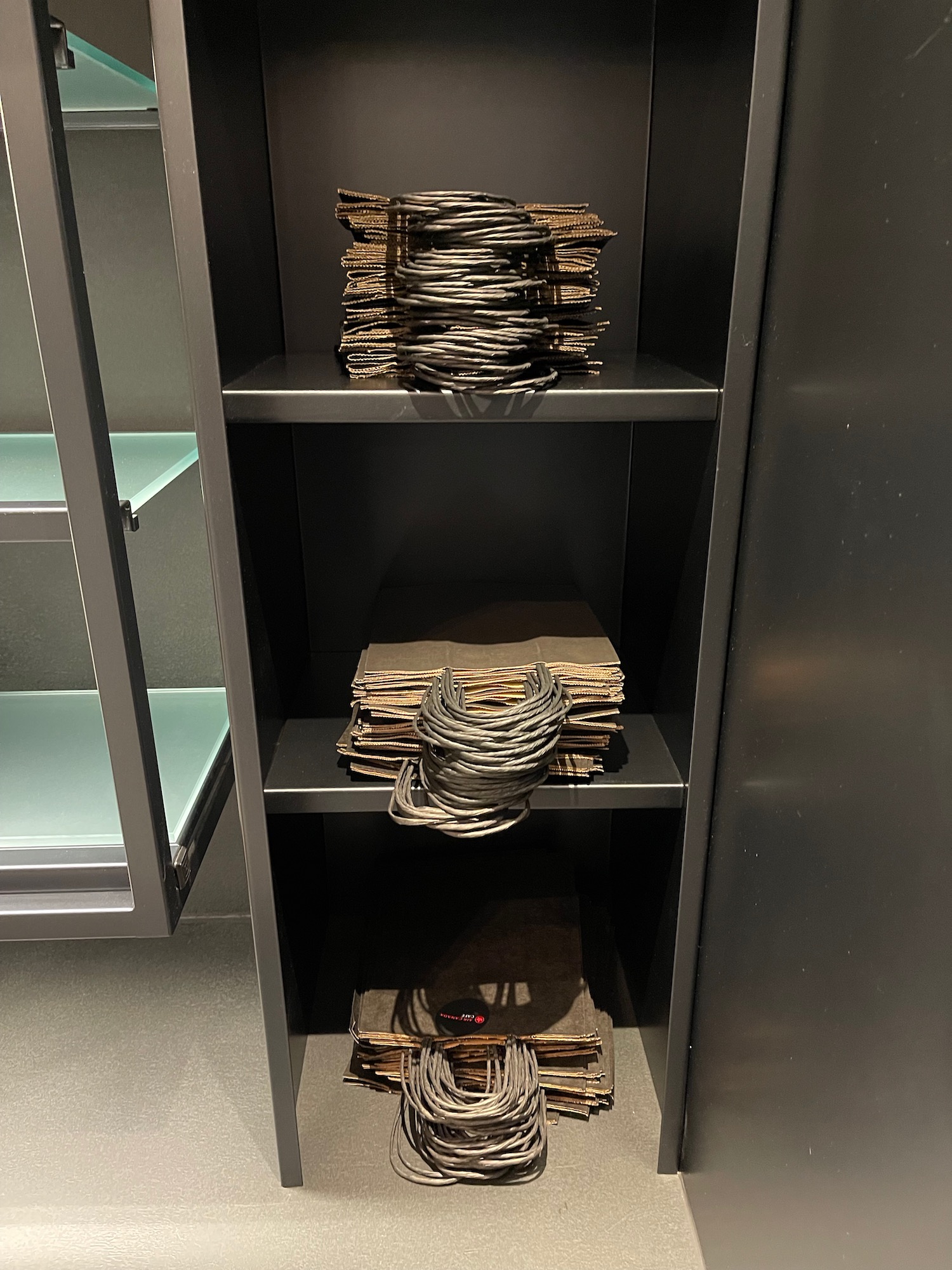 a shelf with black shelves and black objects