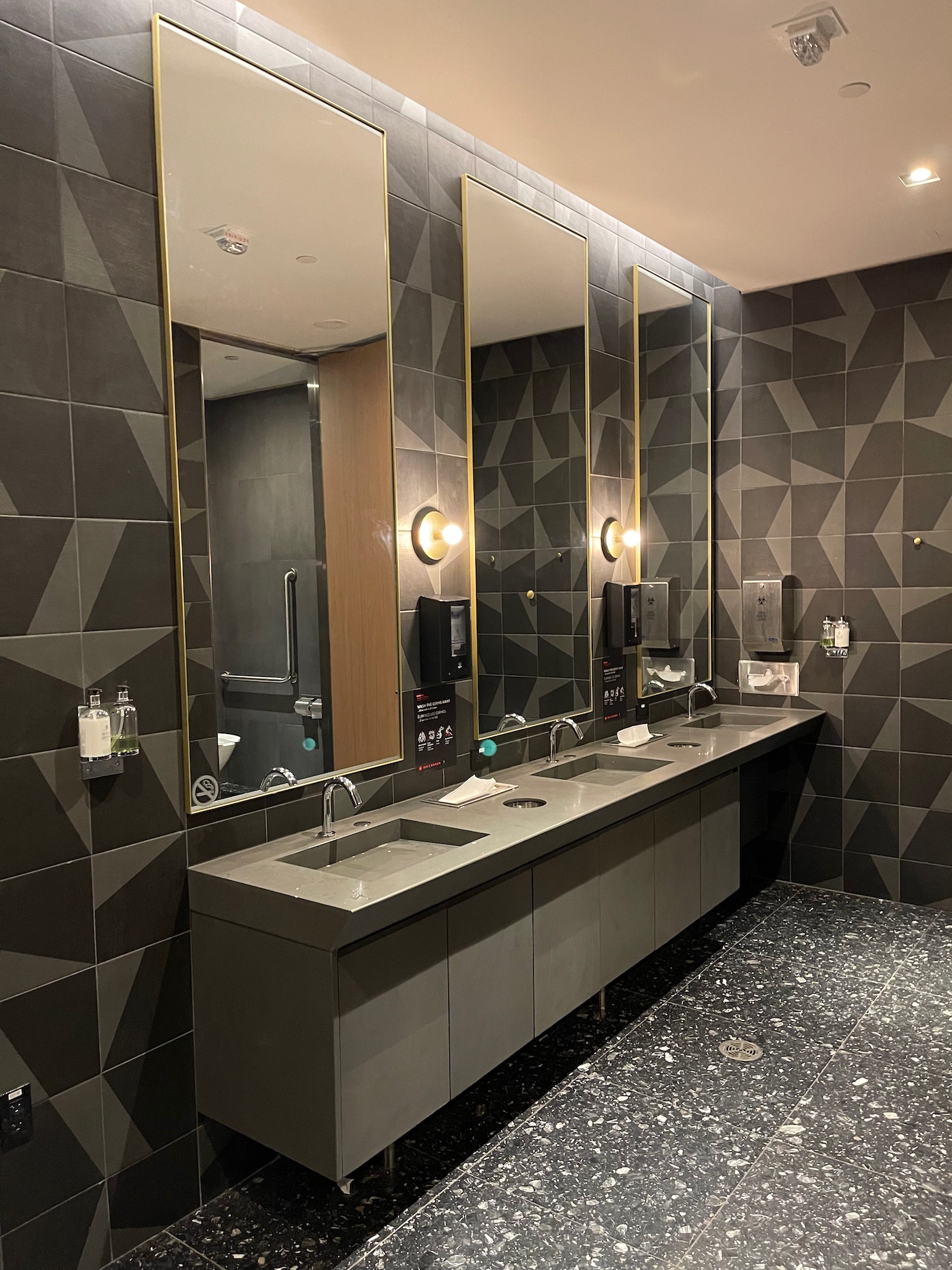 a bathroom with sinks and mirrors