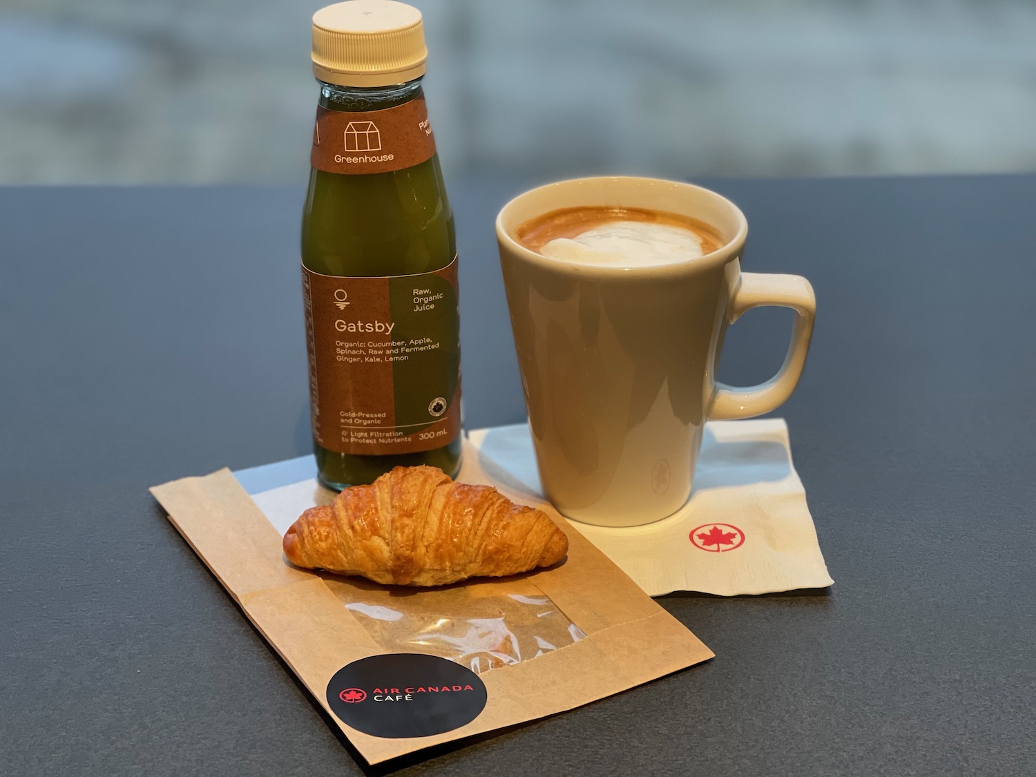 a croissant and a drink on a table