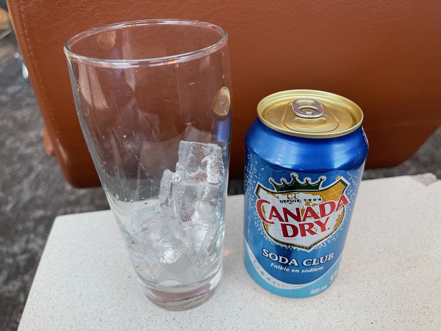 a can of soda and a glass