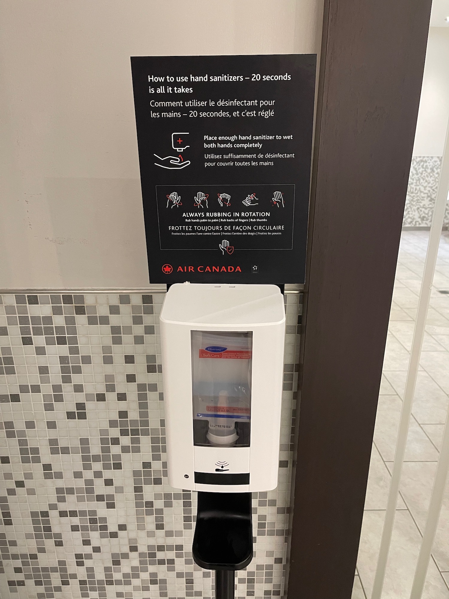 a hand sanitizer dispenser on a wall