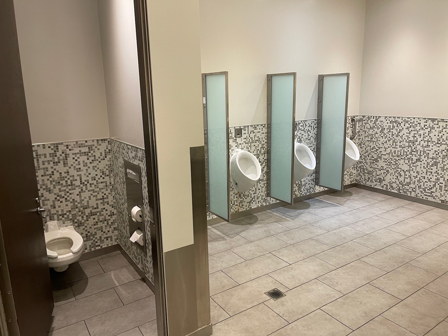 a bathroom with urinals and urinals