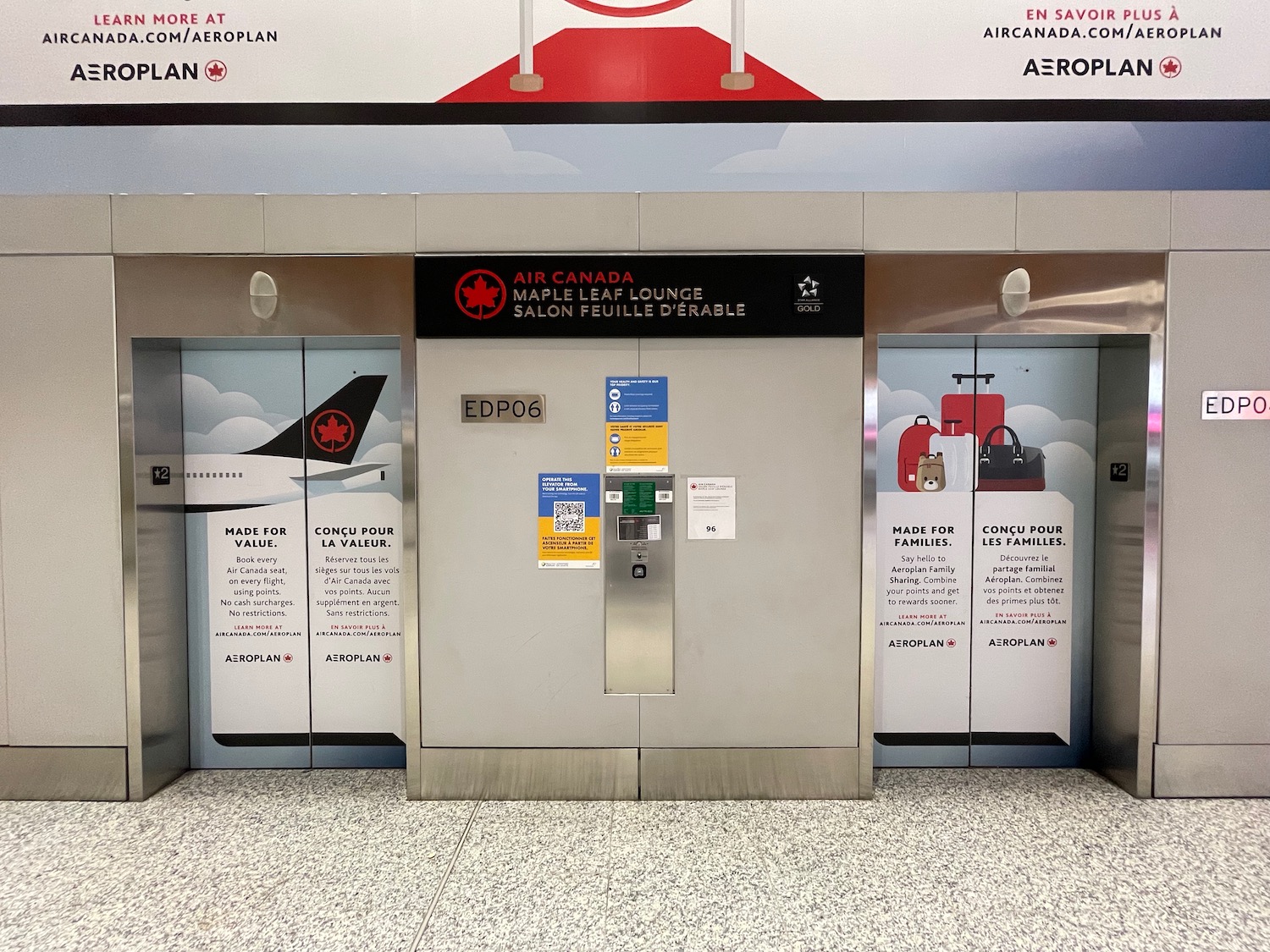 an elevator with signs on the wall