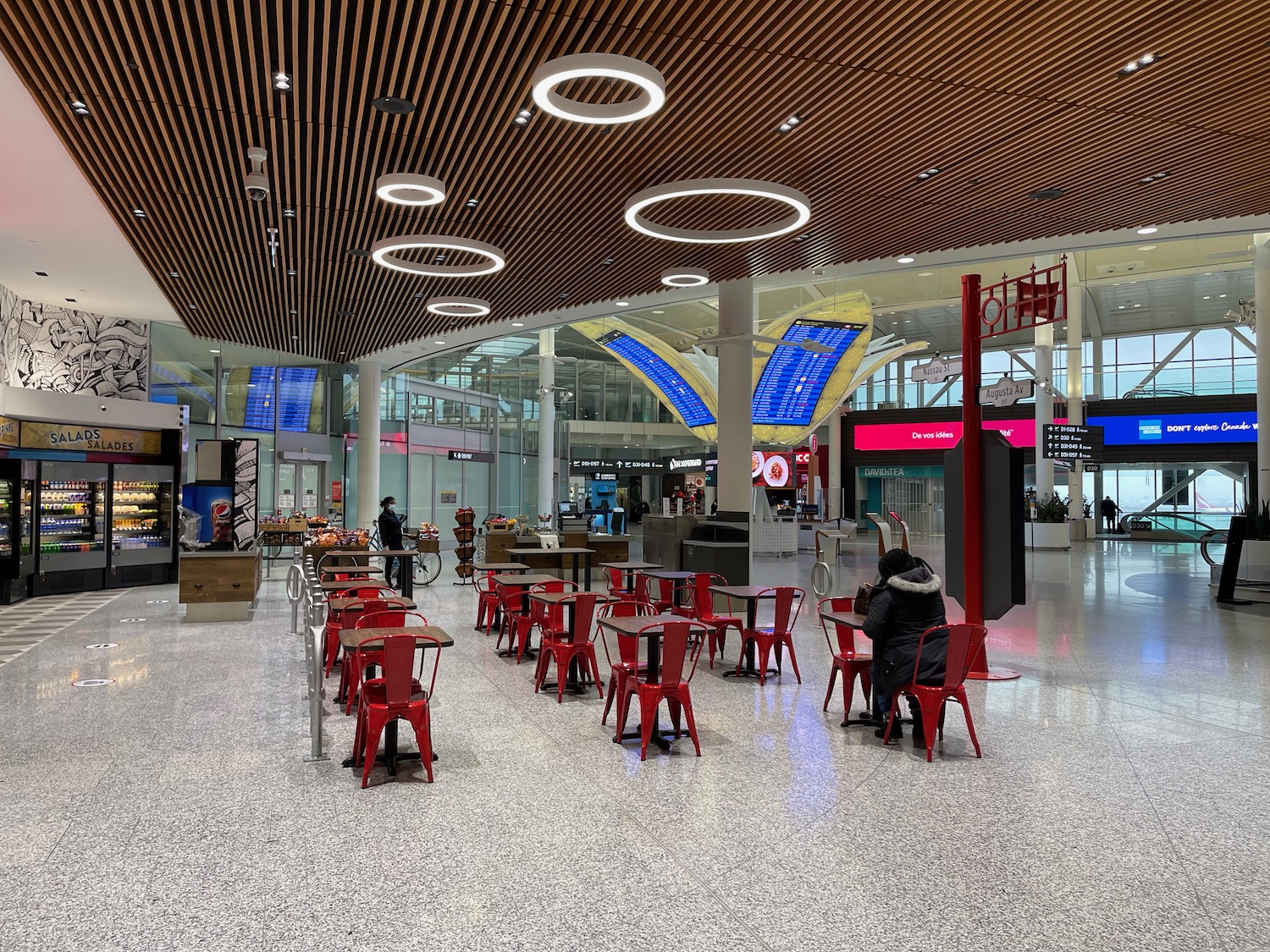 a group of people sitting at tables in a large building