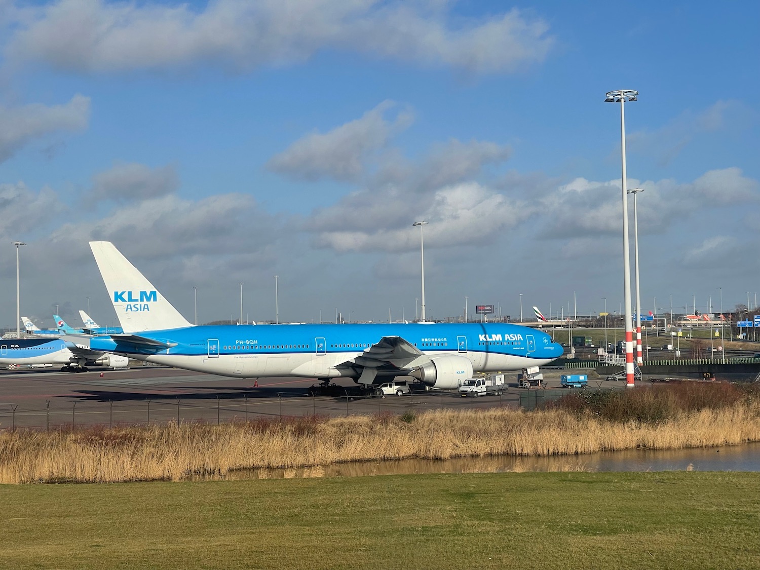 a blue and white airplane on a runway