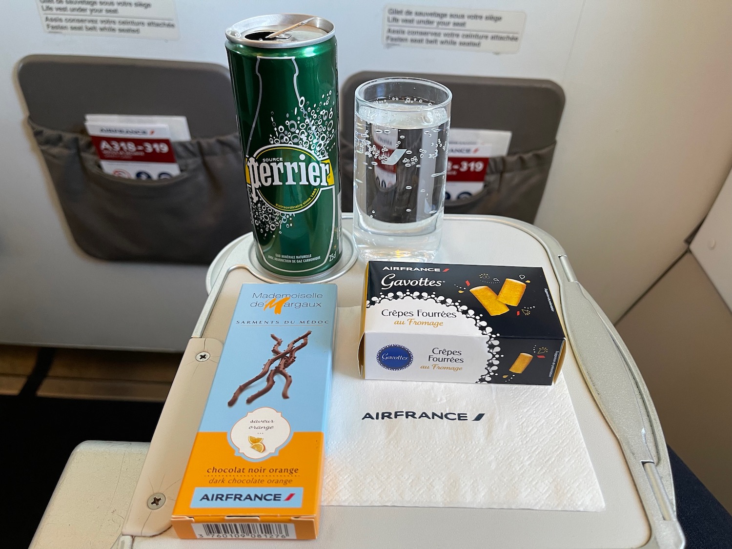 a can and a glass of water on a tray