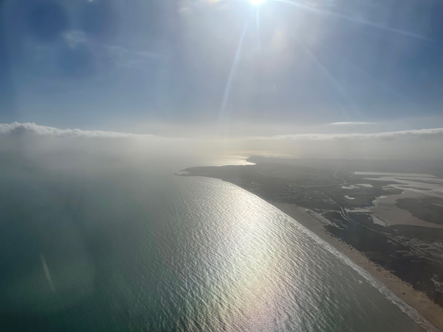 a body of water with a beach and land in the distance