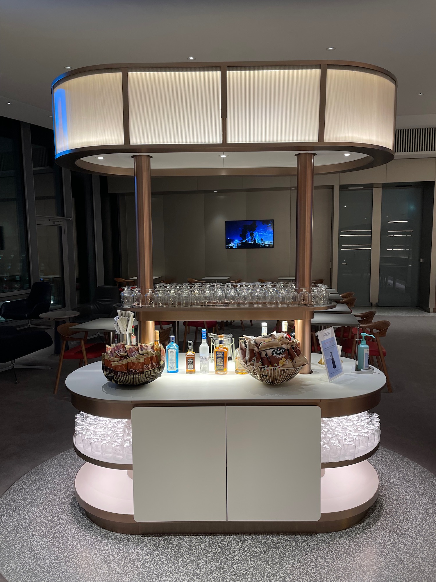 a bar with a basket of glasses and bottles