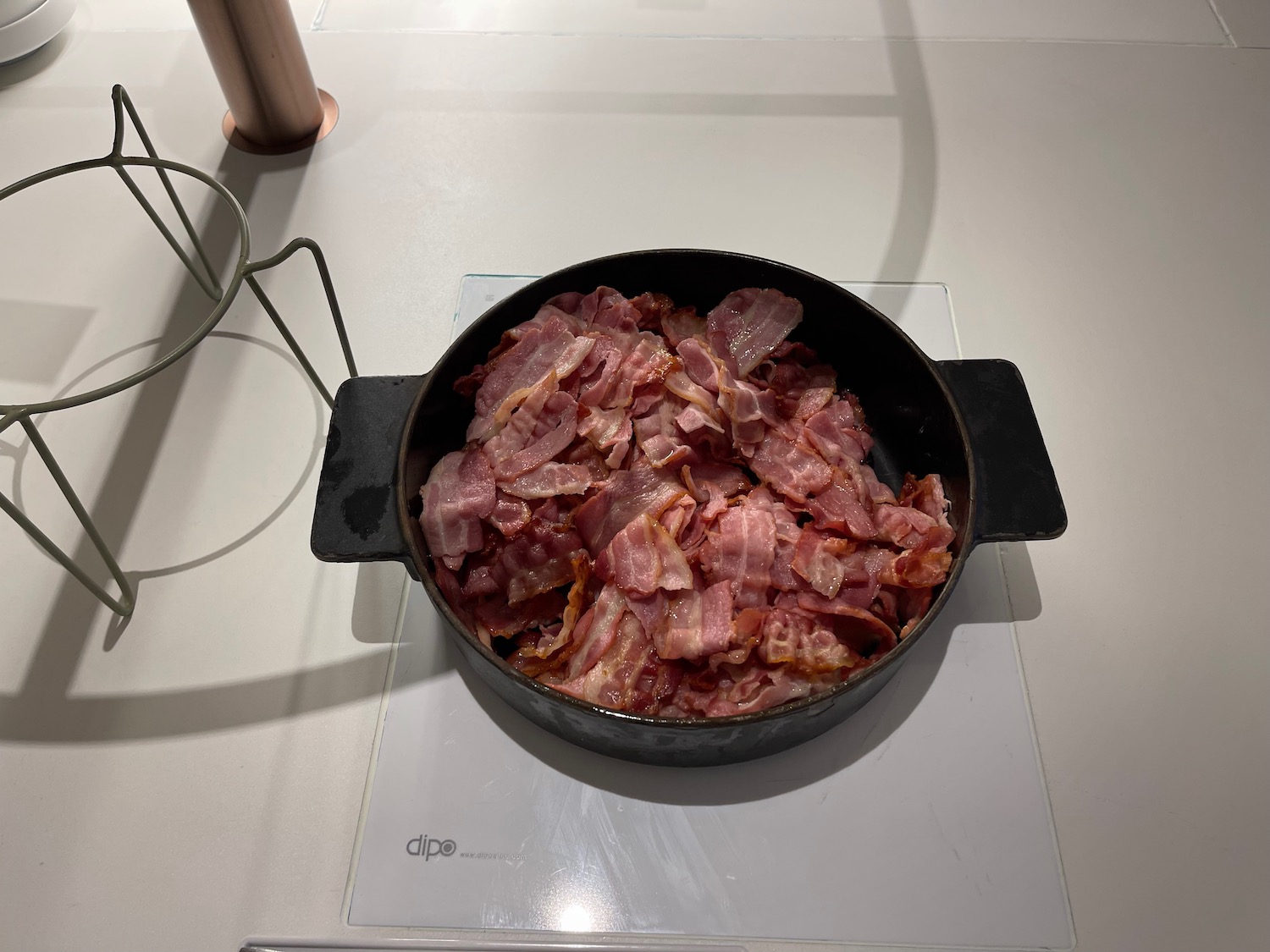 a pan of bacon on a white surface