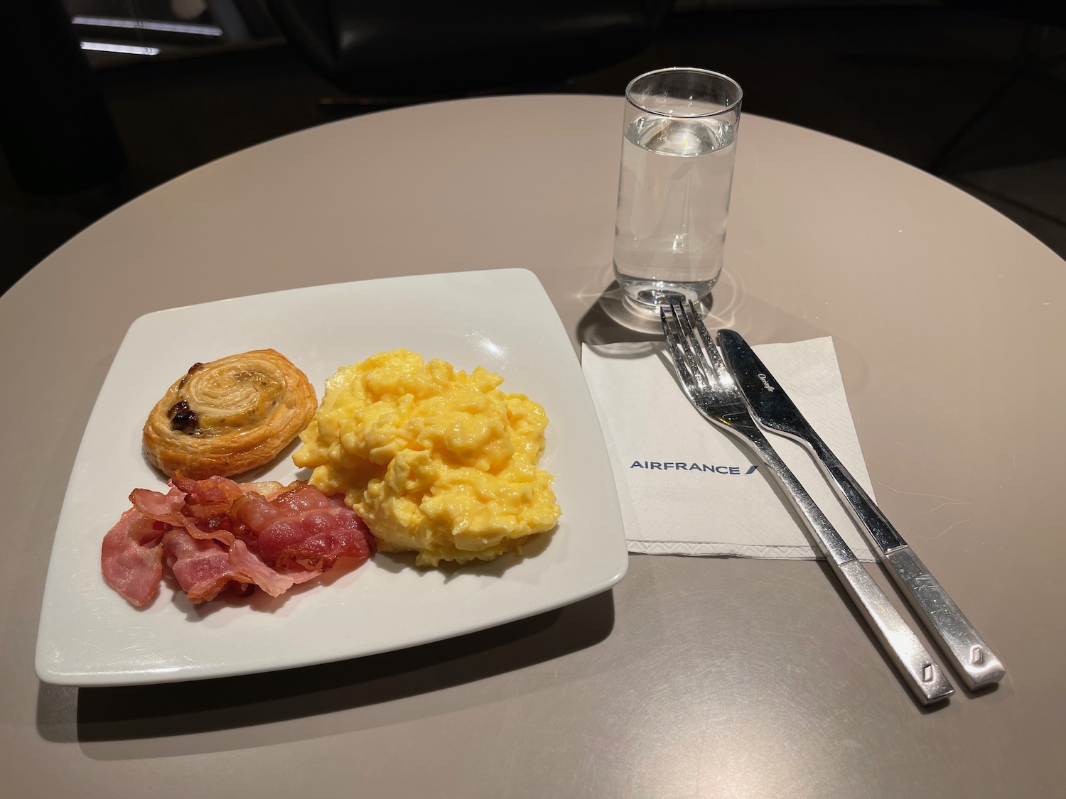 a plate of food and a glass of water on a table