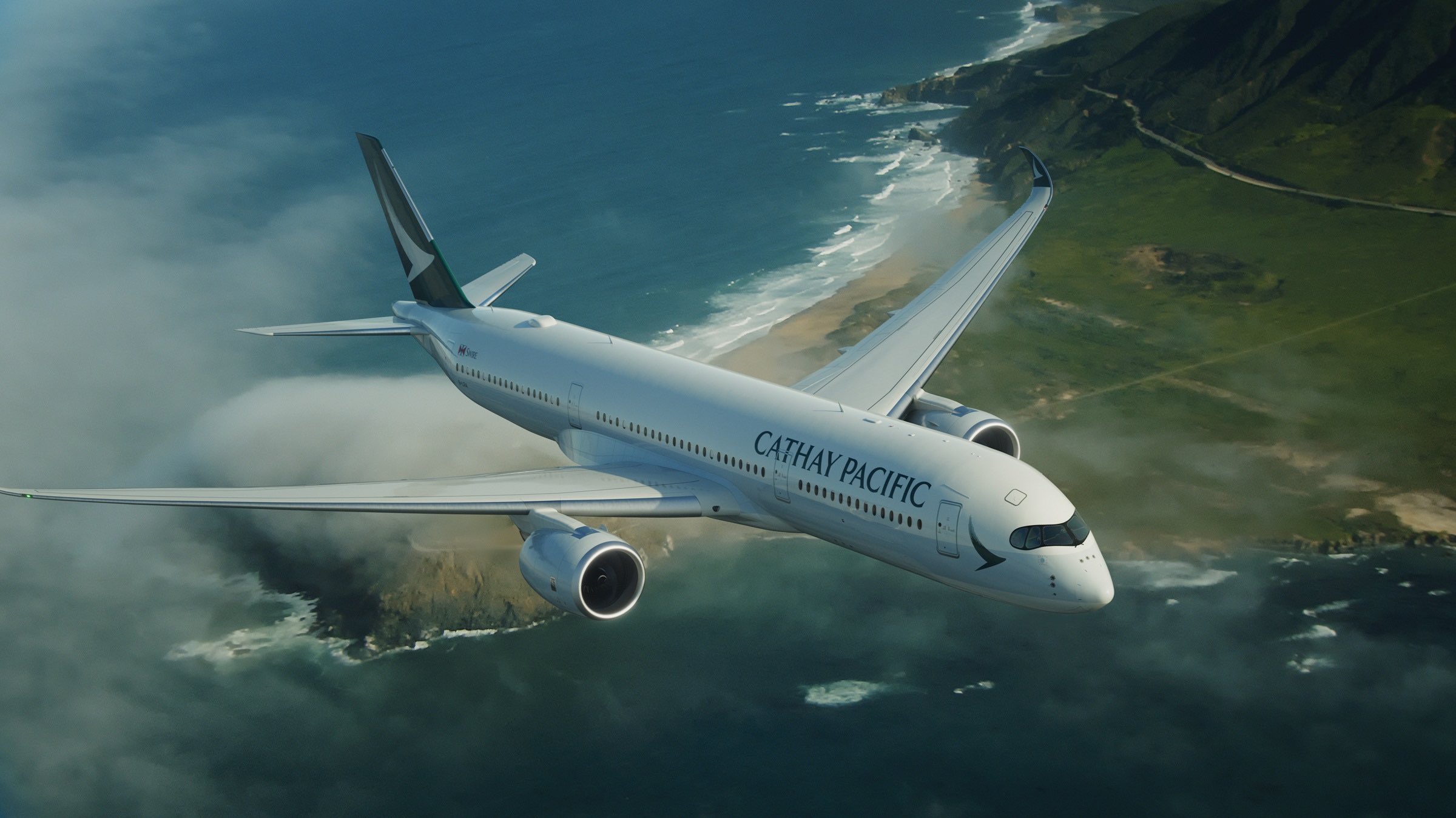 an airplane flying over a beach