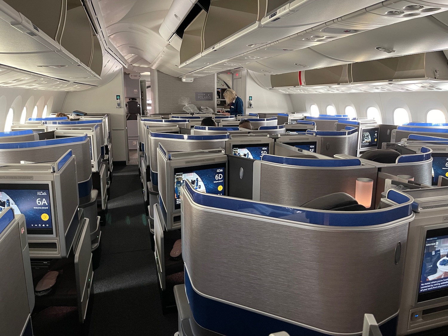 an airplane with rows of seats and a person sitting in the chair