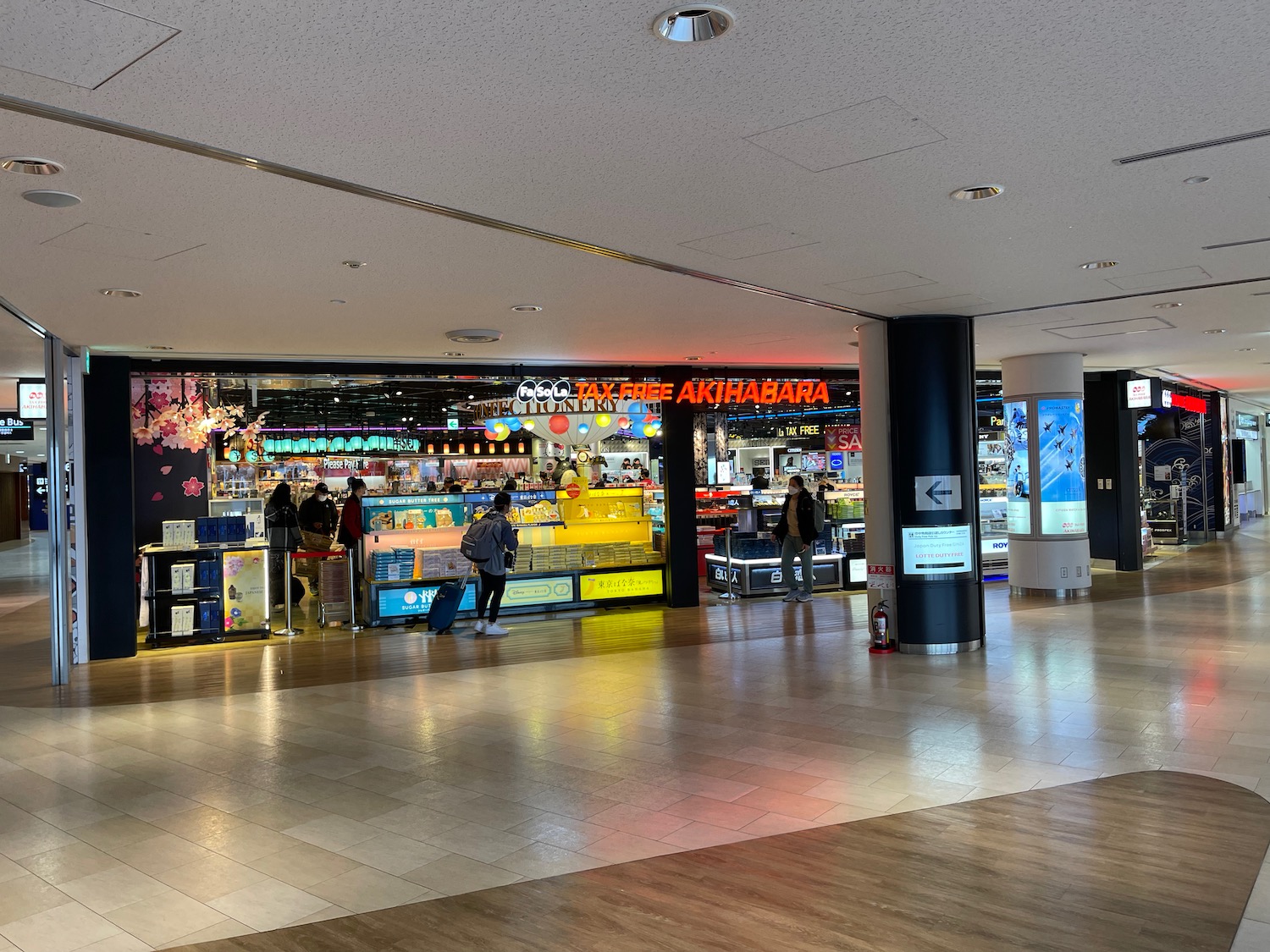 a large room with people walking around