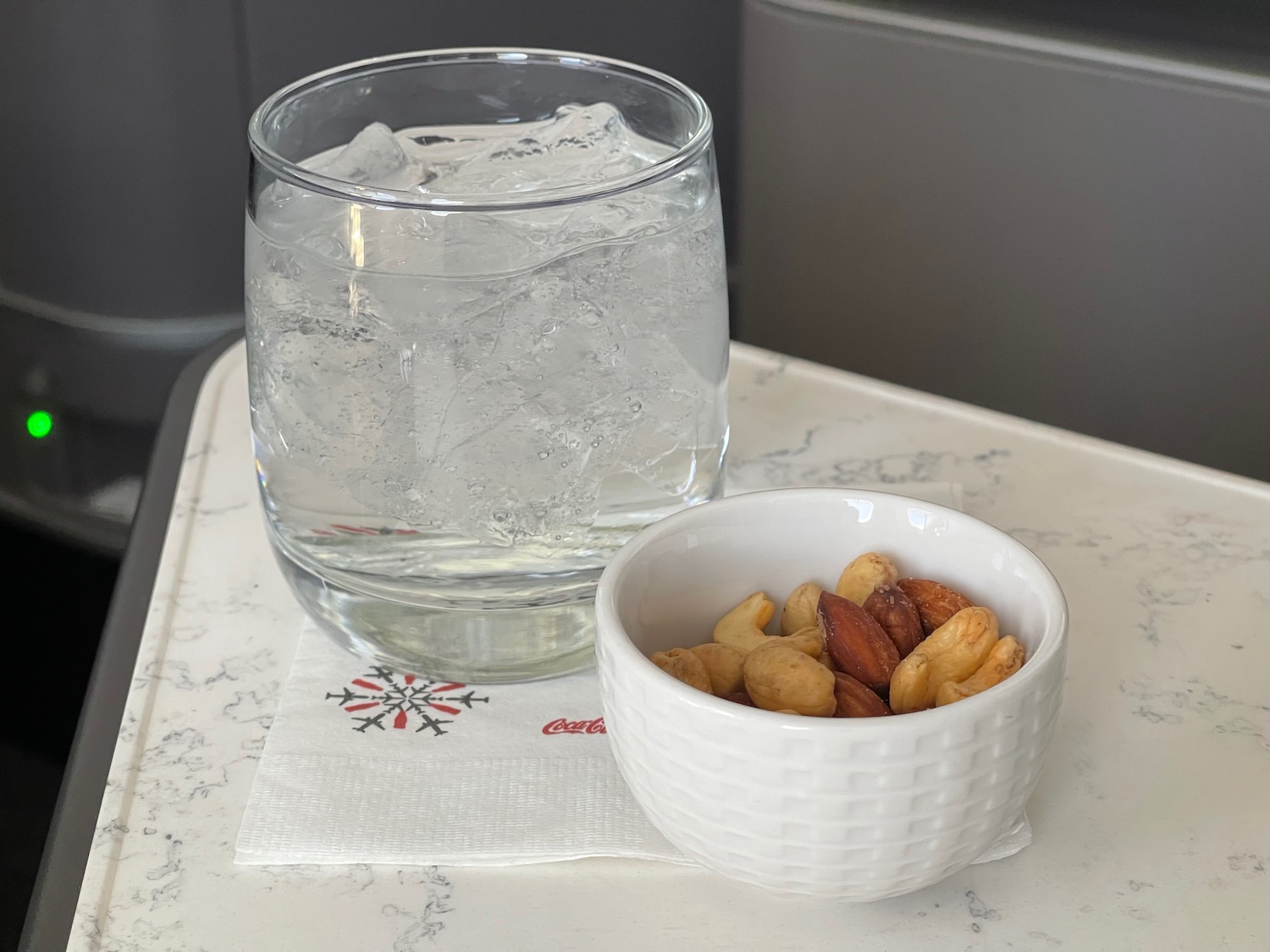 a bowl of nuts and a glass of water