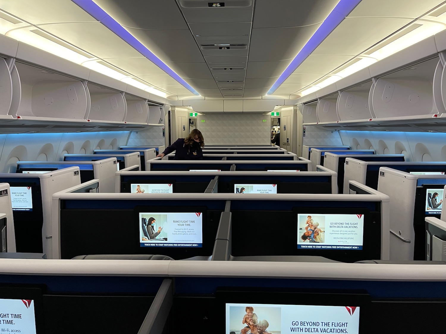 a woman standing in an airplane with computers