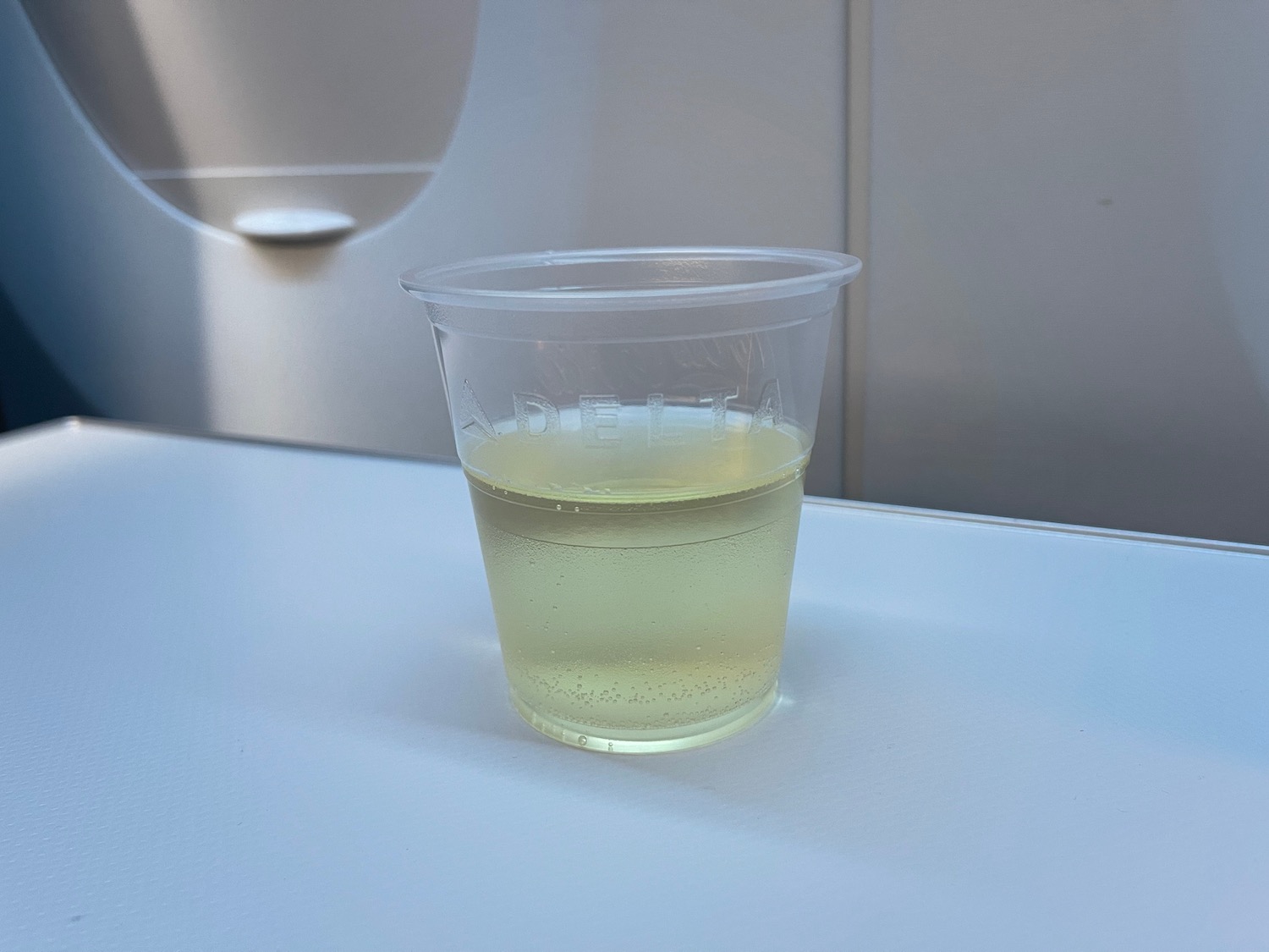 a plastic cup with yellow liquid in it