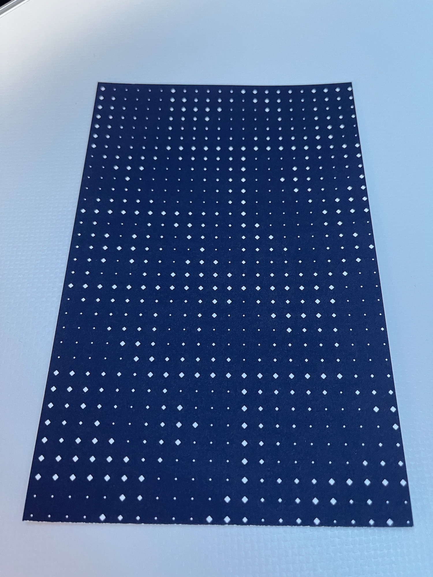 a blue and white rectangular object with white dots