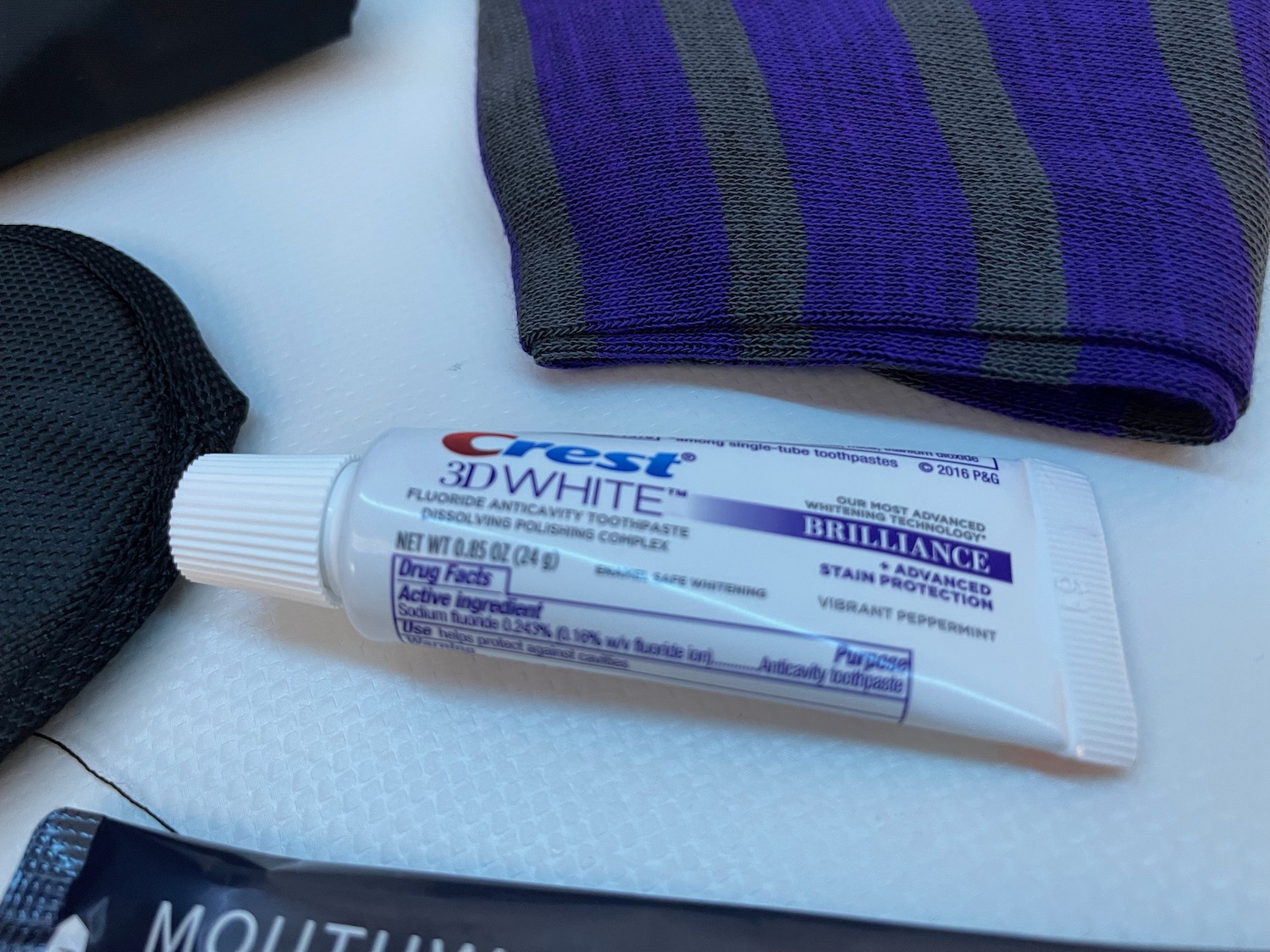 a tube of toothpaste next to a pair of purple and gray socks