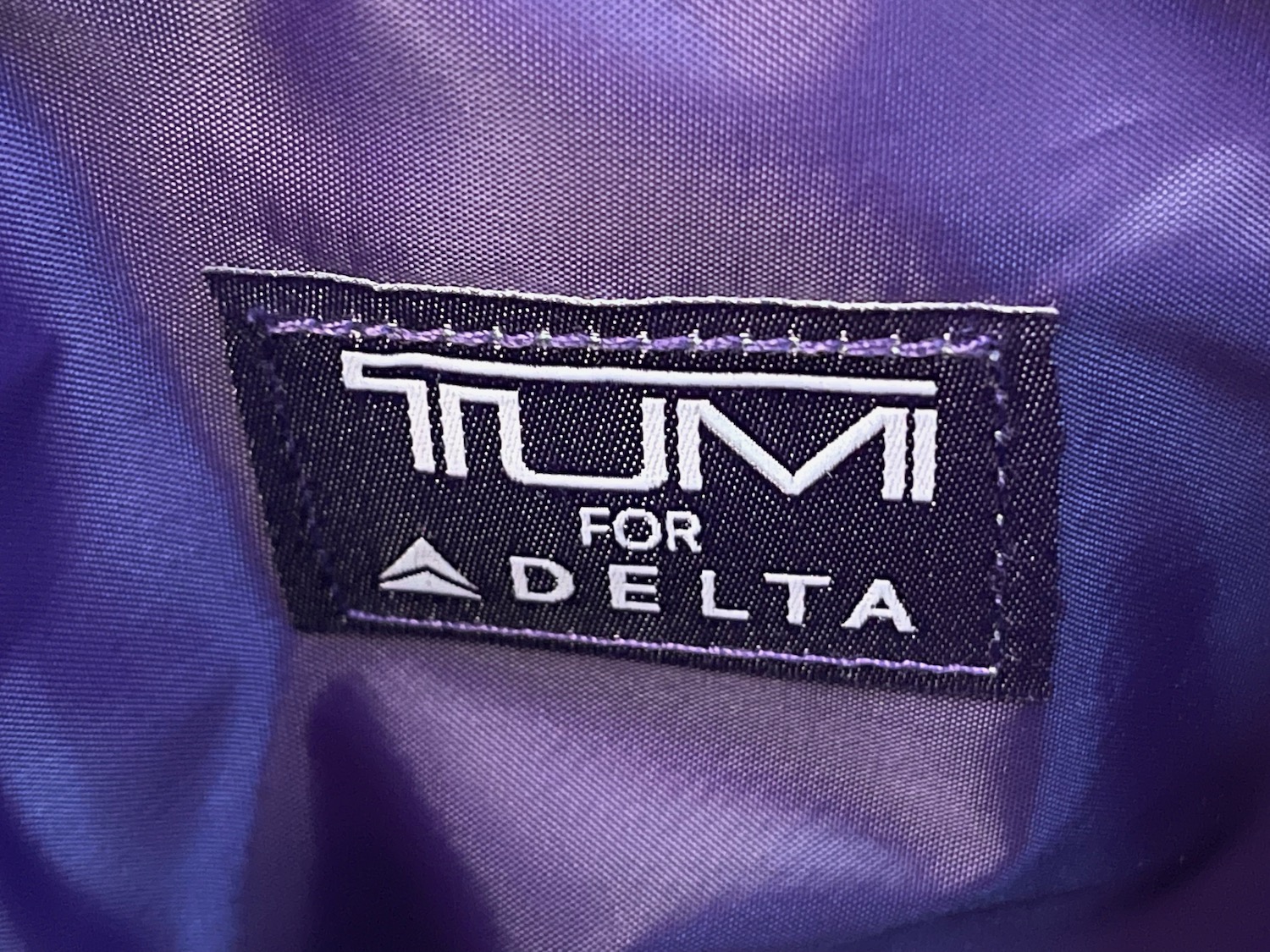 a label on a purple bag