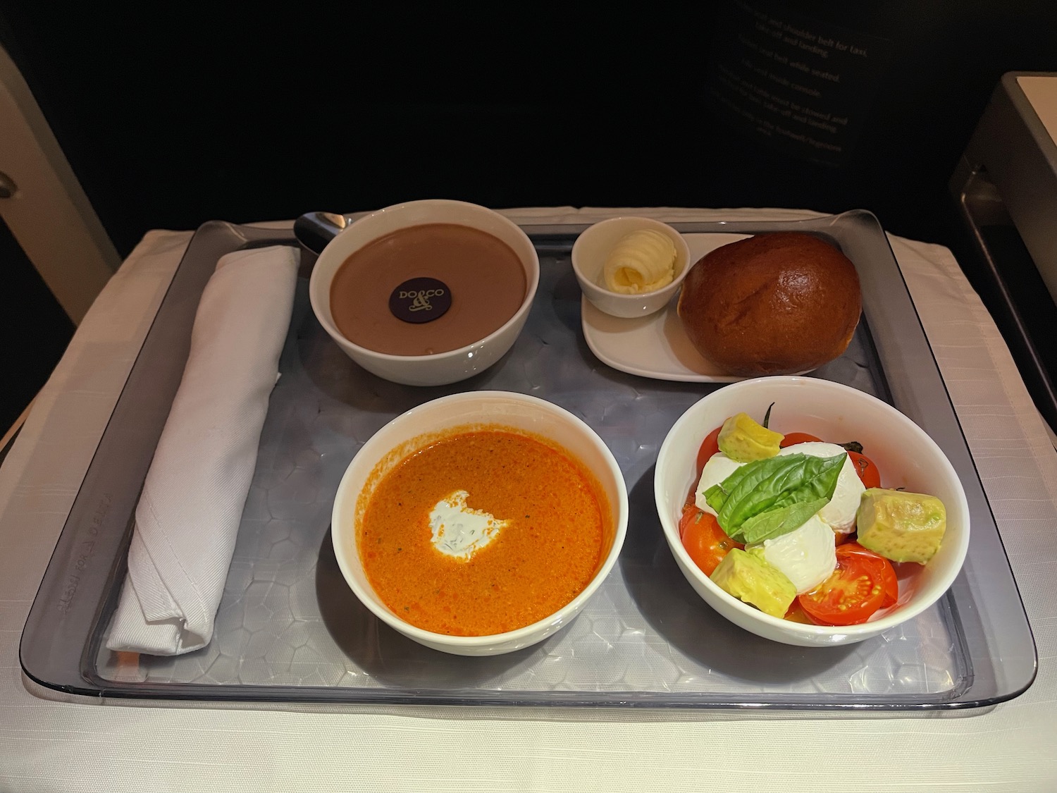 a tray with bowls of soup and bread