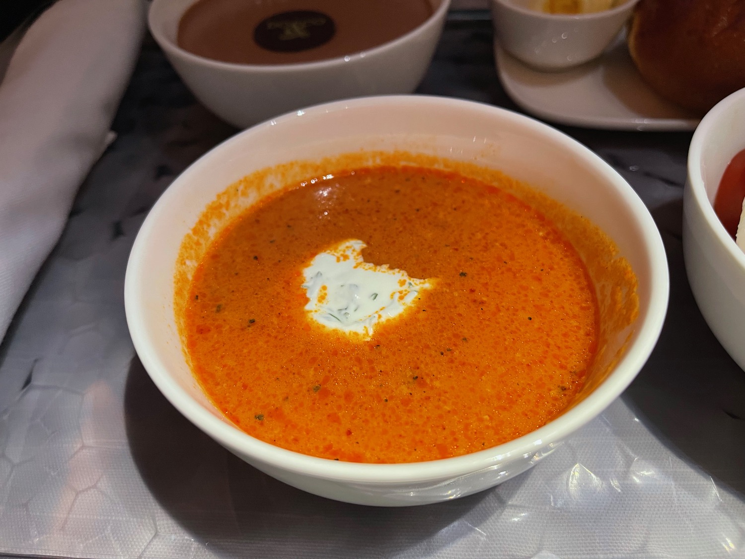 a bowl of soup with a white cream in it