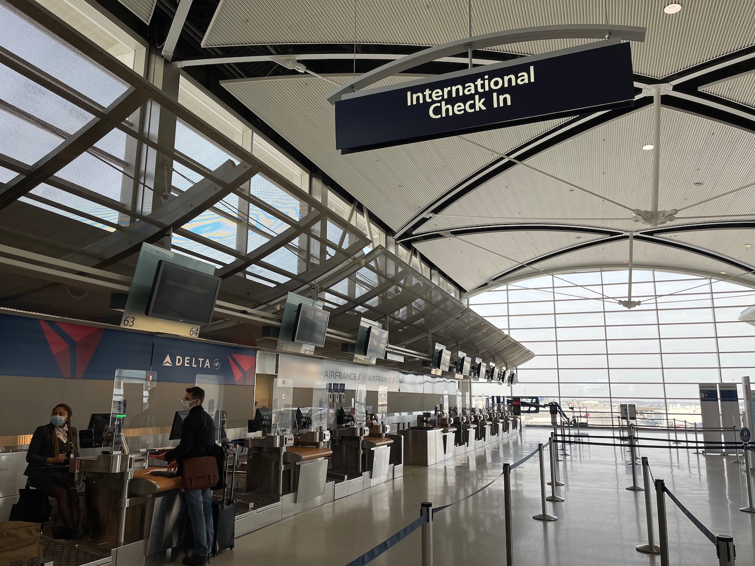 a man standing at counter in an airport