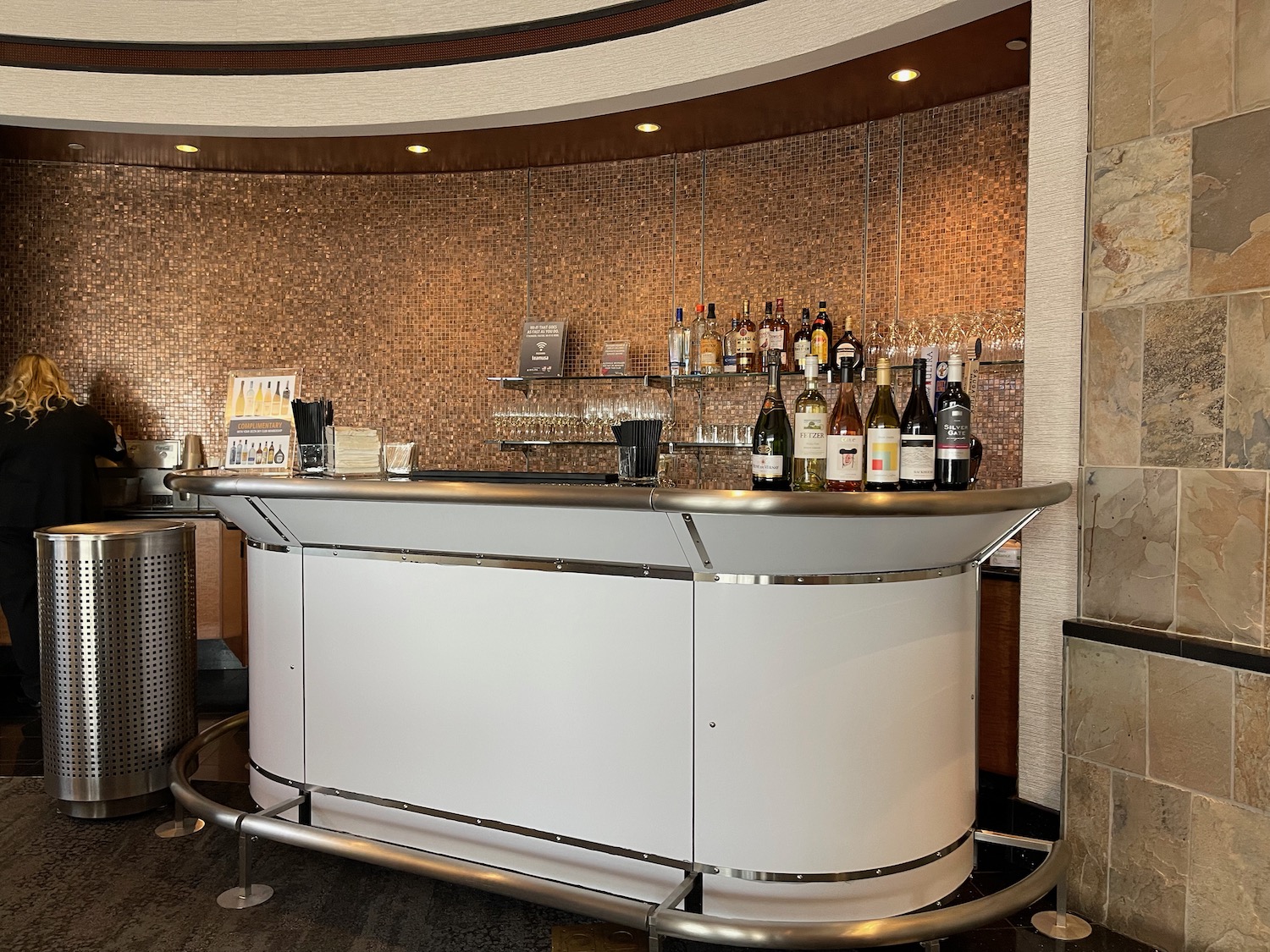 a bar with bottles of wine on the counter