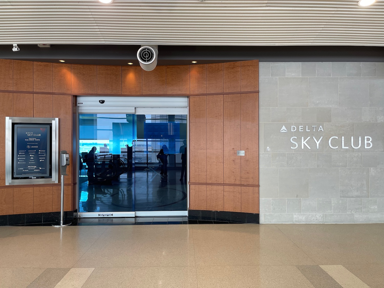 a glass door with a sign on the wall