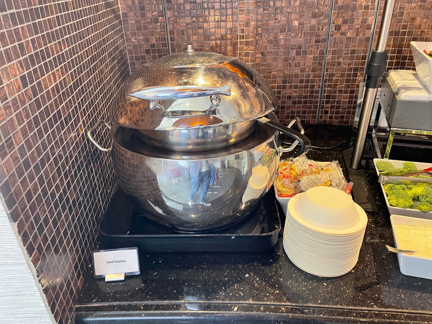 a large silver pot on a black counter