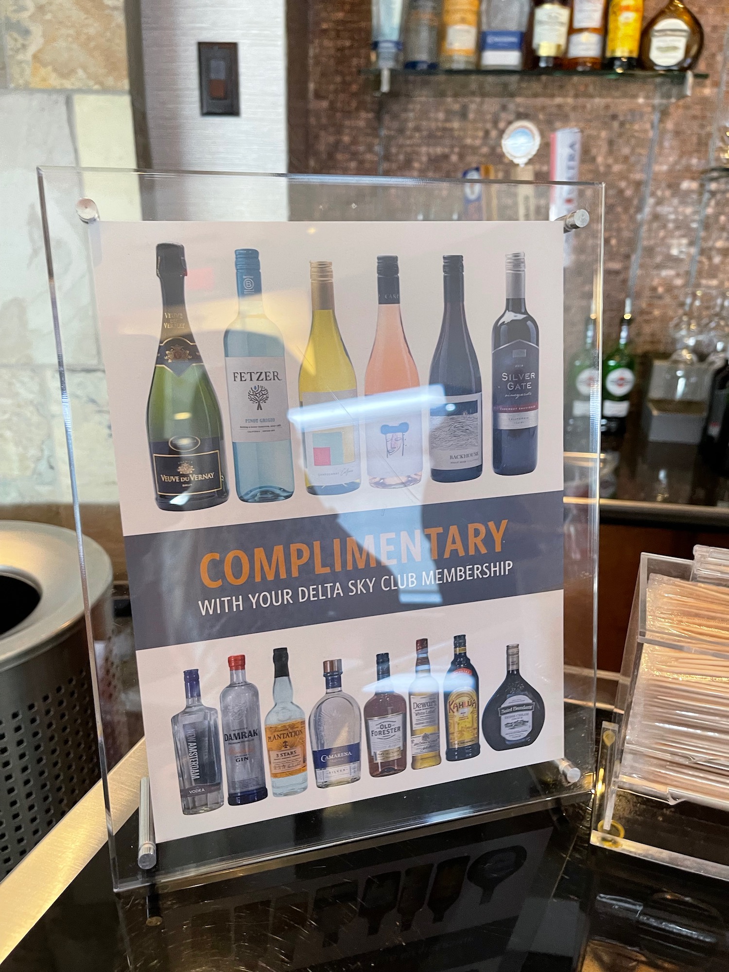 a sign with a picture of bottles on it