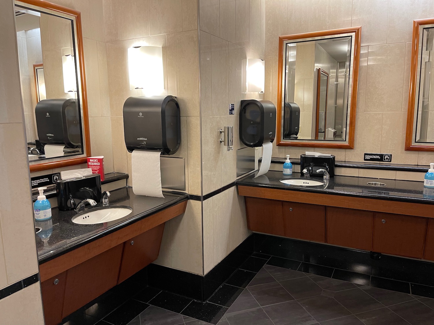 a bathroom with a mirror and a paper towel dispenser