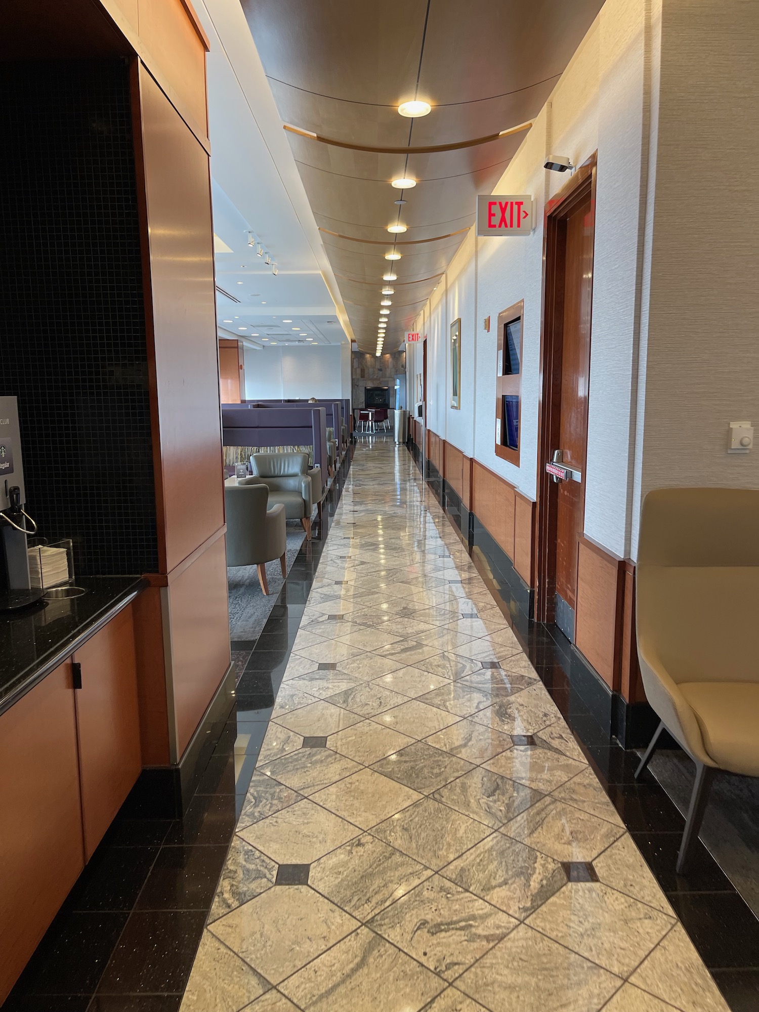 a hallway with chairs and a door