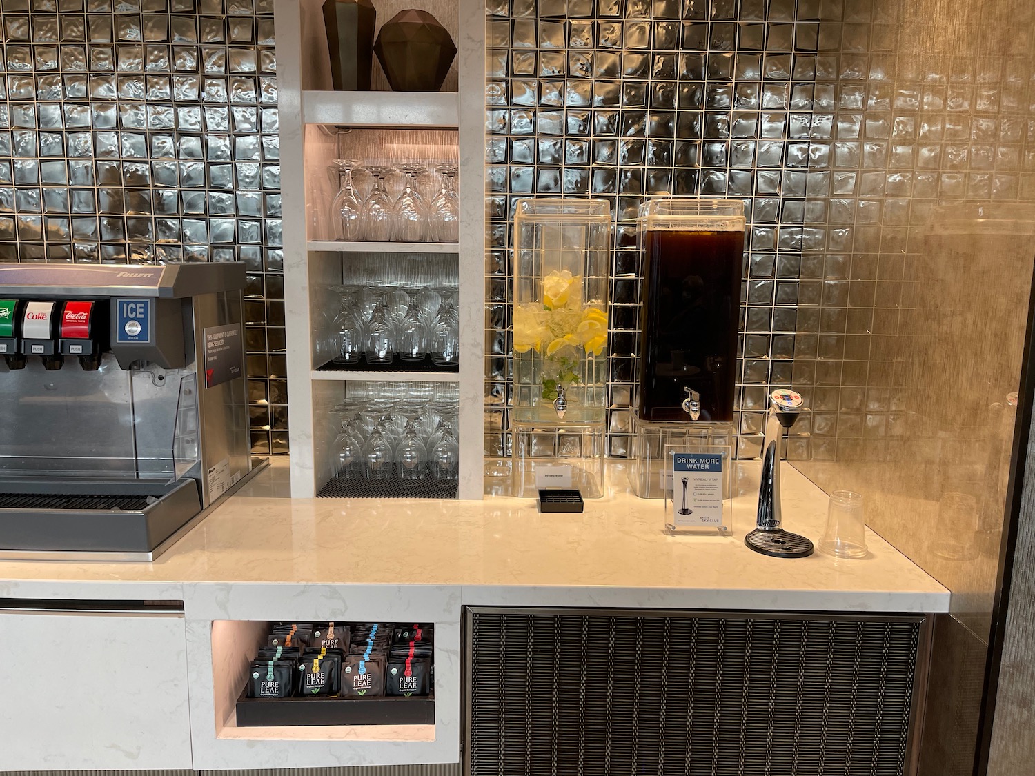 a coffee machine and glasses on a counter