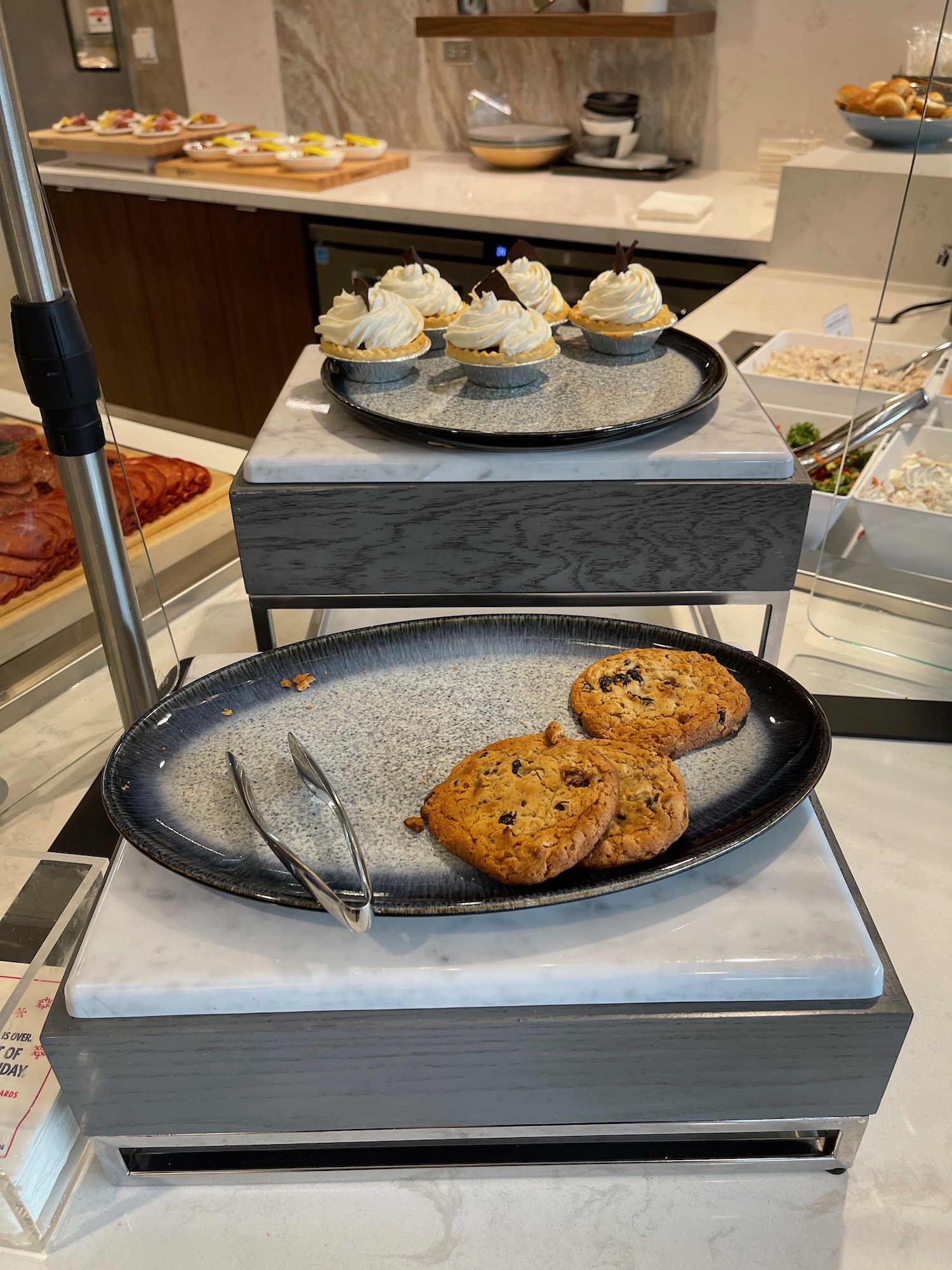 a plate of cookies and cupcakes on a counter